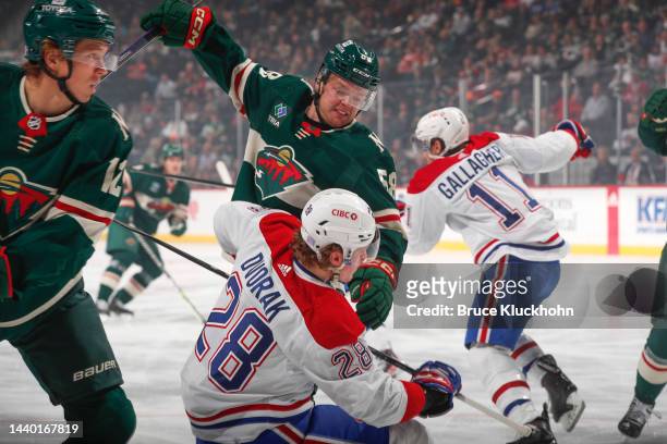 Mason Shaw of the Minnesota Wild takes a faceoff against Christian Dvorak of the Montreal Canadiens during the game at the Xcel Energy Center on...