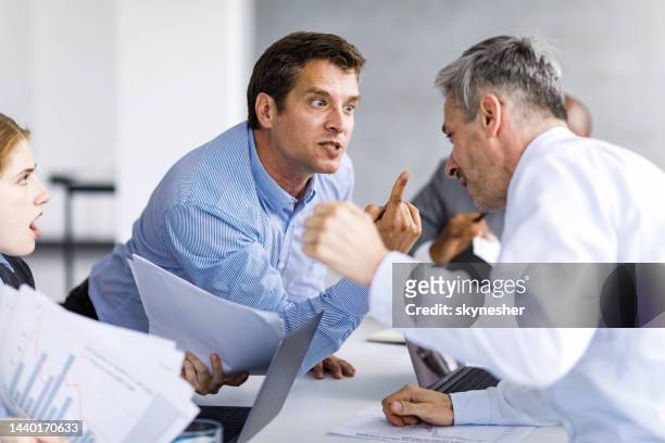 angry business colleagues arguing on a meeting in the office. - agressie stock pictures, royalty-free photos & images