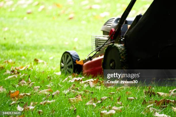 a lawn mower working in the grass - mowing stock pictures, royalty-free photos & images