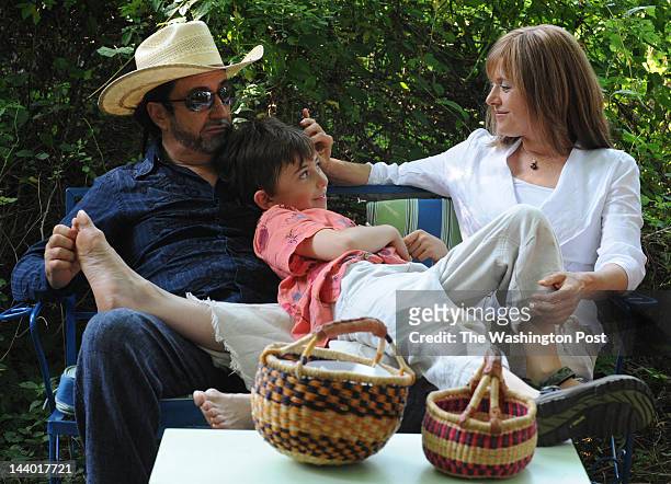 Eduardo Garcia Valseca and Jayne Rager Valseca , sit with their son Emiliano, 9 in a picnic area on their property in Leesburg, Virginia on July 21,...