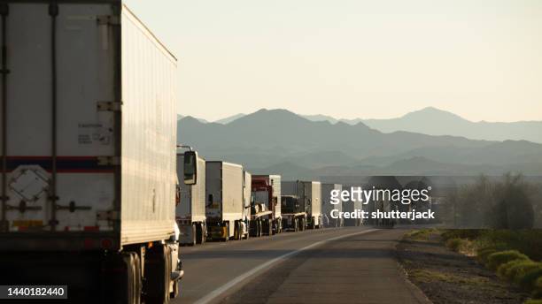 a row of trucks bumper to bumper on a road, san bernardino, california, usa - convoy stock pictures, royalty-free photos & images