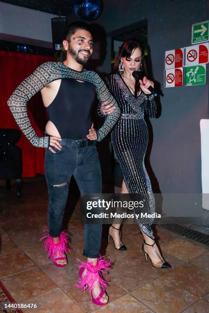 Mexican actress and model Carmen Campuzano teaches a model to walk in heels, during presentation of a special collection of heels for men, on...