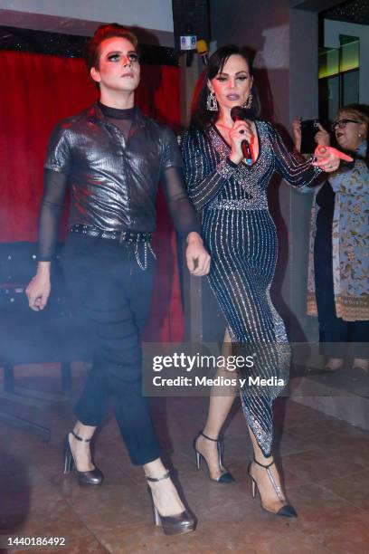 Mexican actress and model Carmen Campuzano teaches a model to walk in heels, during presentation of a special collection of heels for men, on...