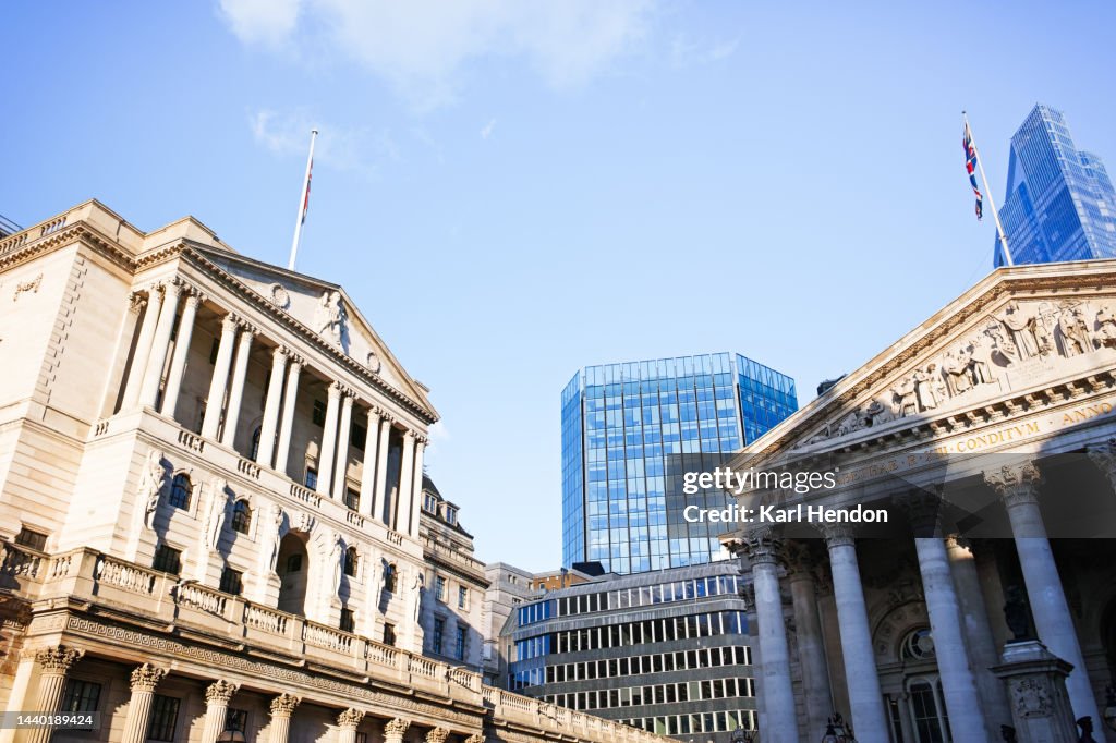 A daytime surface level view looking up at London City buildings