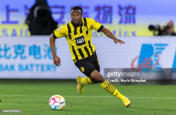 Youssoufa Moukoko of Borussia Dortmund runs with the ball during the Bundesliga match between VfL Wolfsburg and Borussia Dortmund at Volkswagen Arena...