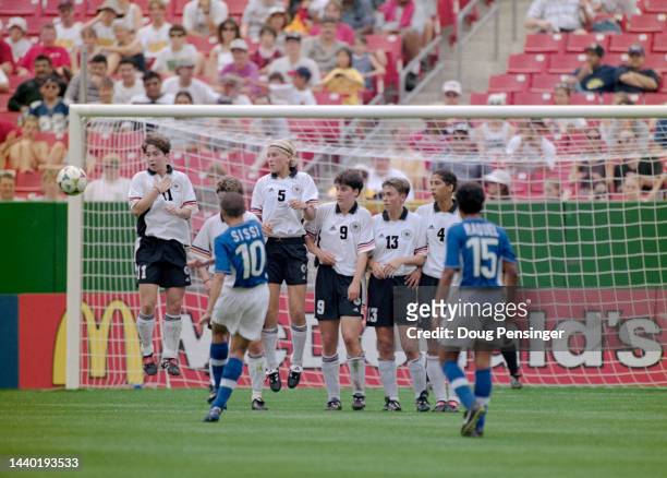 Sissi, Forward and Midfielder for Brazil curls a free kick around the jumping wall defence of Germany to score during their Group B match of the FIFA...