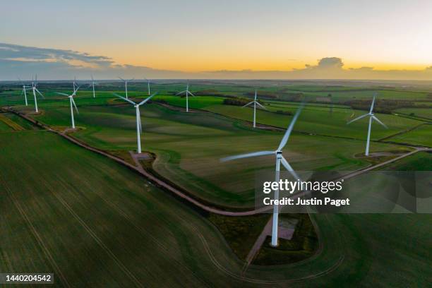 drone view of a wind farm at sunset with multiple wind turbines - 自然の力 ストックフォトと画像