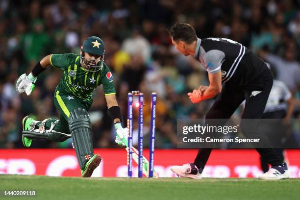 Mohammad Rizwan of Pakistan grounds his bat as Tim Southee of New Zealand attempts to run him out during the ICC Men's T20 World Cup Semi Final match...