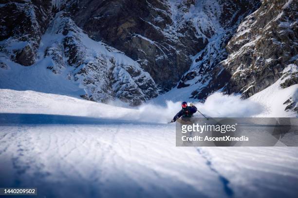 backcountry skier skis fresh powder down a steep slope - winter sport stock pictures, royalty-free photos & images