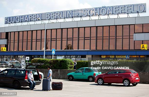 Passengers arrive by car on May 8, 2012 at the Schoenefeld airport, one of the two Berlin airports. The scheduled opening of Berlin's new main...