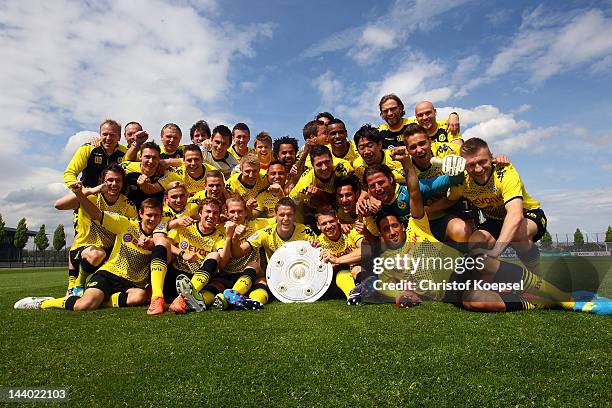 Borussia Dortmund players celebrate their Bundesliga victory with the trophy at the training ground on May 8, 2012 in Dortmund, Germany.