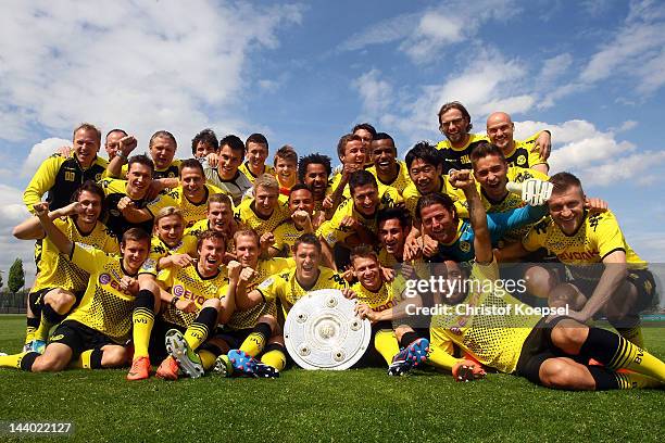 Borussia Dortmund players celebrate their Bundesliga victory with the trophy at the training ground on May 8, 2012 in Dortmund, Germany.