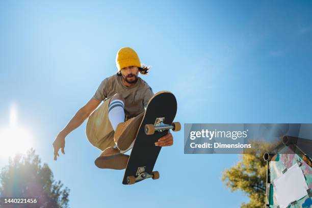 skater jumping over camera. - skater stock pictures, royalty-free photos & images