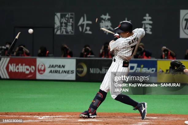 Outfielder Teruaki Sato of Japan breaks his bat as he hits a grounder in the seventh inning during the game between Samurai Japan and Australia at...