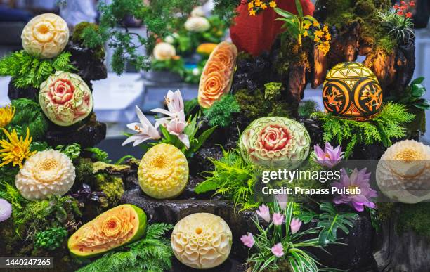 thai sculpted fruit - food sculpture stock pictures, royalty-free photos & images
