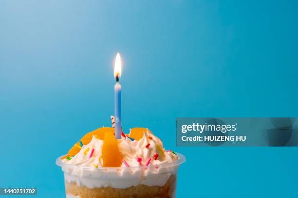 birthday cupcake with one blue candle - birthday candle stock pictures, royalty-free photos & images
