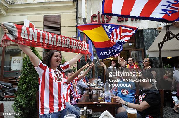 Supporters of Atletico de Madrid celebrate in front of a restaurant in Bucharest's old city center on May 8, 2012 on the eve of the UEFA Europa...