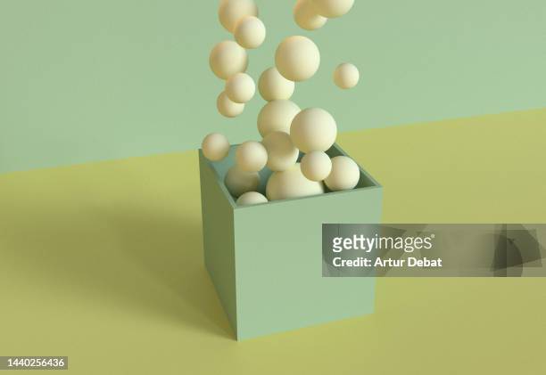 digital 3d render with large group of spheres falling inside open cube. - global gift stock pictures, royalty-free photos & images