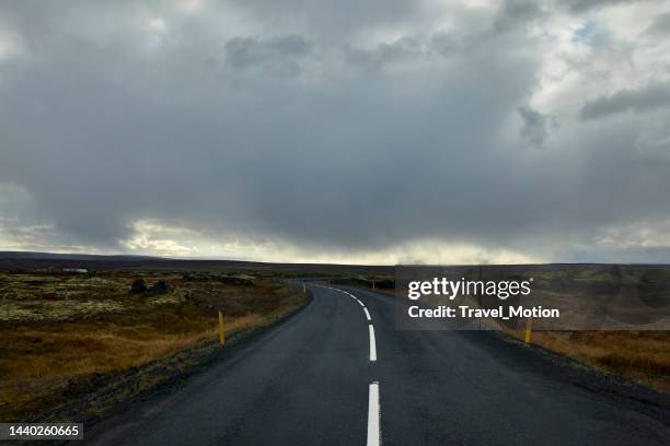 ring road and cloudscape at autumn in north iceland - dark country road stock pictures, royalty-free photos & images