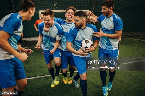 soccer players celebrating a goal - indoor football pitch stock pictures, royalty-free photos & images