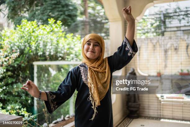 portrait of a cute islamic girl dancing - alpha stock pictures, royalty-free photos & images