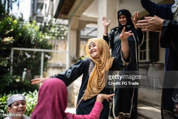 multi generation arab family dancing at home - dancing funny carefree woman stock pictures, royalty-free photos & images