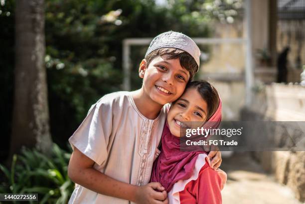 portrait of happy islamic siblings at home - arabic boy stock pictures, royalty-free photos & images