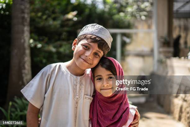 portrait of happy islamic siblings at home - arabic boy stock pictures, royalty-free photos & images