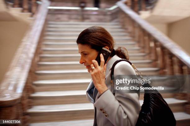 Sen. Olympia Snowe talks on the phone while heading to the Senate Republican Caucus policy luncheon May 8, 2012 in Washington, DC. Moments before,...