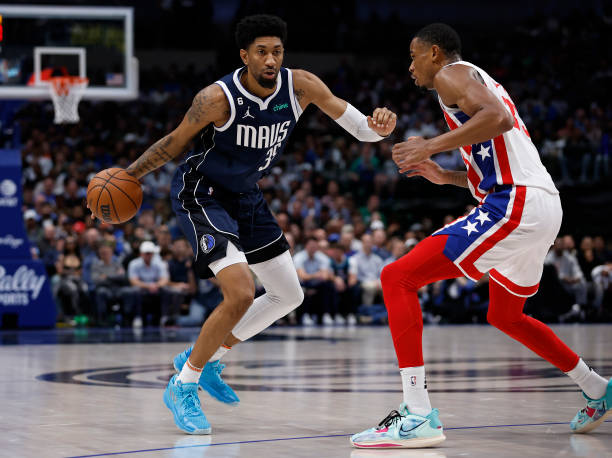 Christian Wood of the Dallas Mavericks dribbles against Nic Claxton of the Brooklyn Nets in the second half of the game at American Airlines Center...