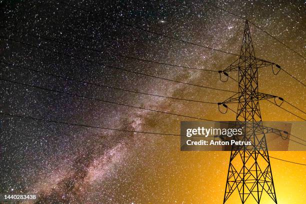 high voltage towers on the background of the starry sky. power outage, blackout - power mast stock pictures, royalty-free photos & images