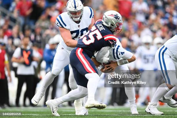 Sam Ehlinger of the Indianapolis Colts is sacked by Josh Uche of the New England Patriots during a game at Gillette Stadium on November 6, 2022 in...