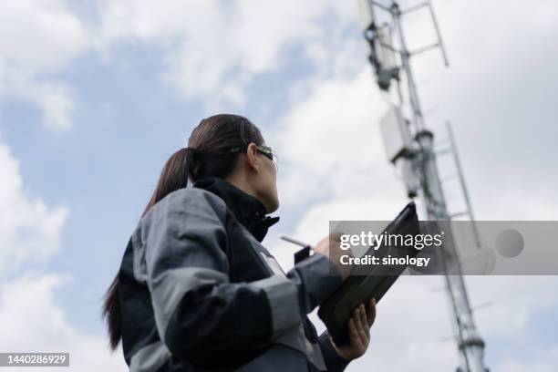 5g communication engineer is testing signal station - 塔 ストックフォトと画像