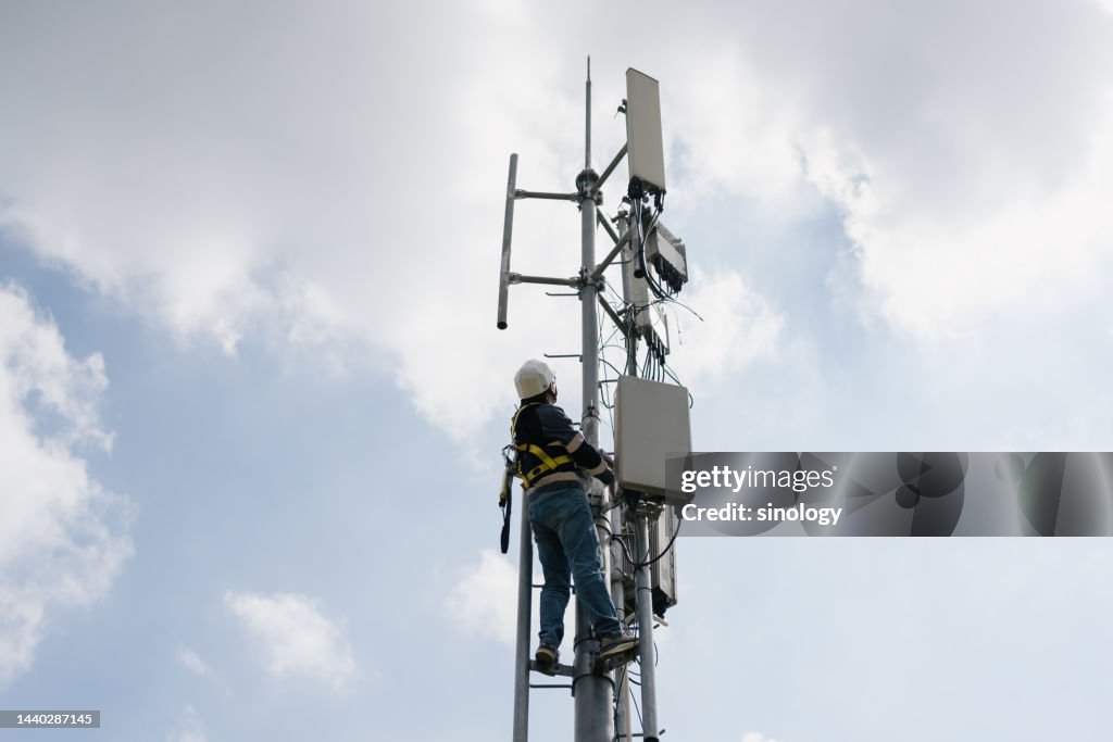Worker is installing 5G Telecommunication Base Station