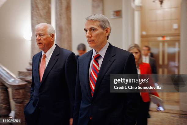 Sen. Saxby Chambliss and U.S. Sen. Rob Portman head for the Senate Republican Caucus policy luncheon at the U.S. Capitol May 8, 2012 in Washington,...