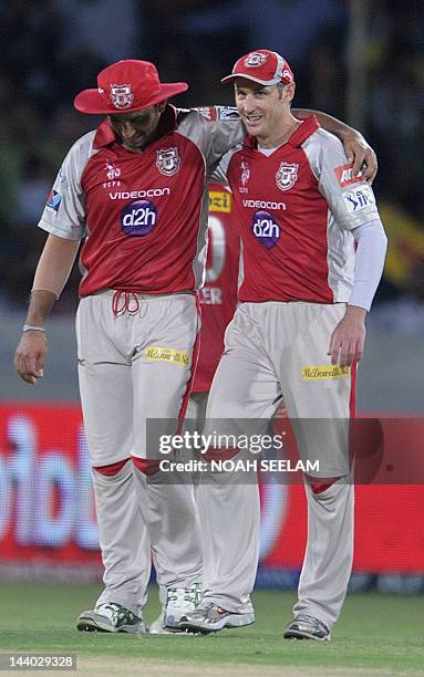 Kings XI Punjab captain David Hussey celebrates with his team member Azar Mahamood after winning the match during the IPL Twenty20 cricket match...