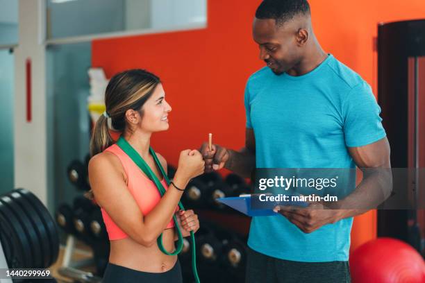 sports training in the gym with personal trainer - personal trainer stock pictures, royalty-free photos & images