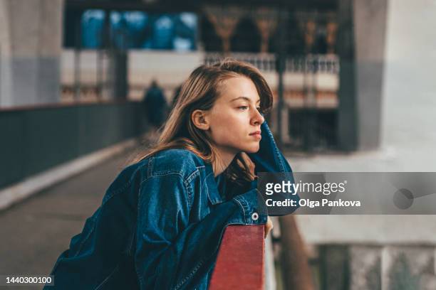 serious melancholic teenage girl walks in the port. - stress emotivo imagens e fotografias de stock