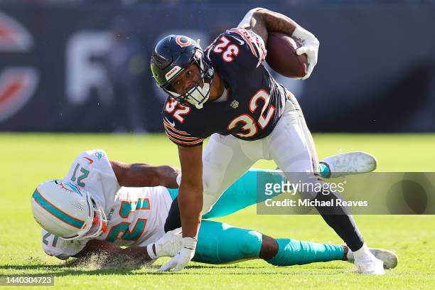 David Montgomery of the Chicago Bears stiff arms Eric Rowe of the Miami Dolphins at Soldier Field on November 06, 2022 in Chicago, Illinois.