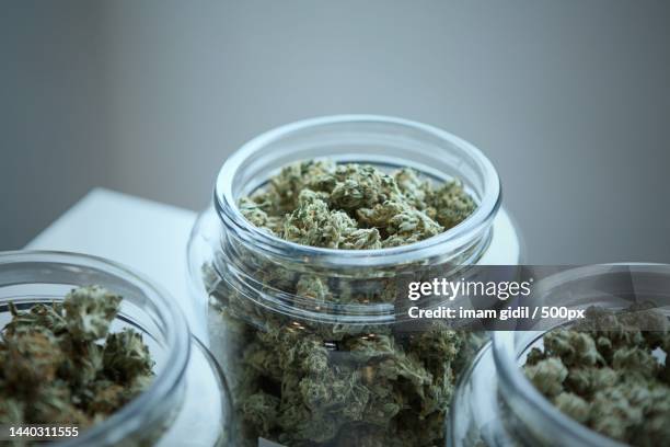 close-up of marijuana in jar on table - medical marijuana law stock pictures, royalty-free photos & images