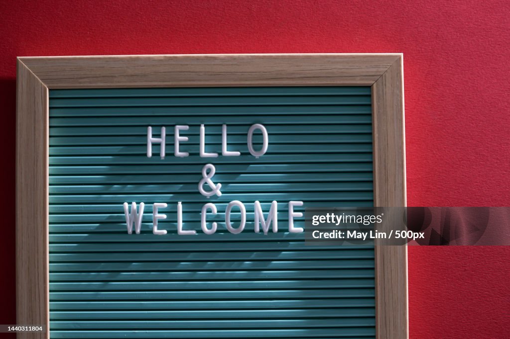 Hello and welcome text on letter board against red background,Malaysia
