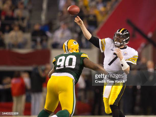 Ben Reothlisberger of the Pittsburgh Steelers releases the ball just before he is hit by B.J. Raji of the Green Bay Packers during Super Bowl XLV at...