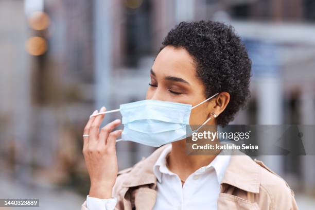 freedom, end of covid and black woman remove face mask in city urban bokeh after corona virus. trust, safety and outdoor compliance in post covid 19 headshot of a young person after getting vaccine - end of life care stock pictures, royalty-free photos & images