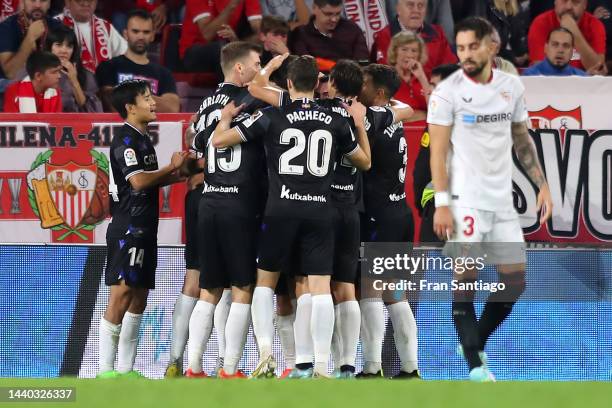 Brais Mendez of Real Sociedad celebrates with teammates after scoring their team's second goal during the LaLiga Santander match between Sevilla FC...