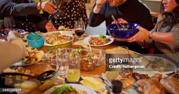 table laden with food at dinner party - adult eating no face stock pictures, royalty-free photos & images