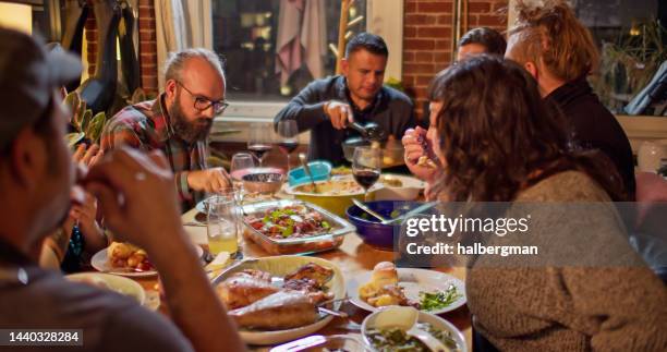 dinner party in loft apartment - potluck stock pictures, royalty-free photos & images