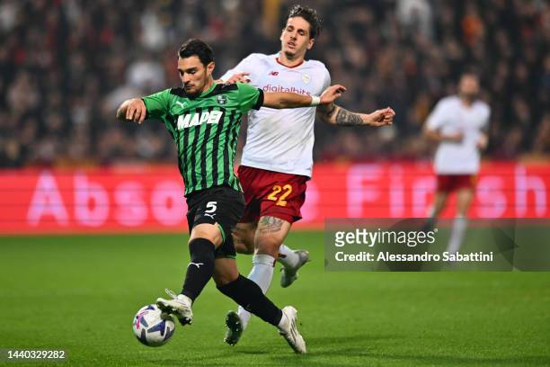 Kaan Ayhan of US Sassuolo battles for possession with Nicolo Zaniolo of AS Roma during the Serie A match between US Sassuolo and AS Roma at Mapei...