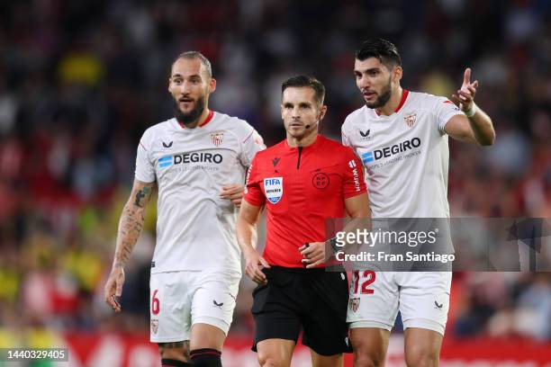 Nemanja Gudelj and Rafa Mir of Sevilla FC interact with referee Carlos Del Cerro Grande during the LaLiga Santander match between Sevilla FC and Real...