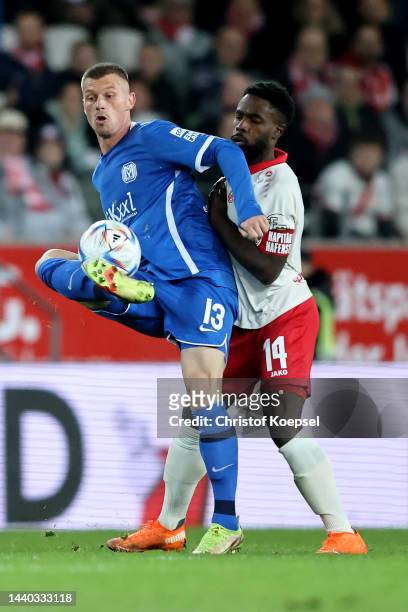 Daniel Heber of Essen challenges Marvin Pourie of Meppen during the 3. Liga match between Rot-Weiss Essen and SV Meppen at Stadion an der...