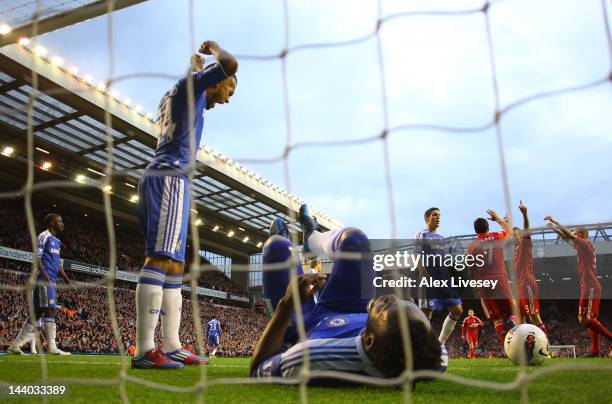 Ryan Bertrand of Chelsea shows his frustration as Daniel Agger of Liverpool celebrates scoring their third goal with Luis Suarez and Martin Skrtel of...